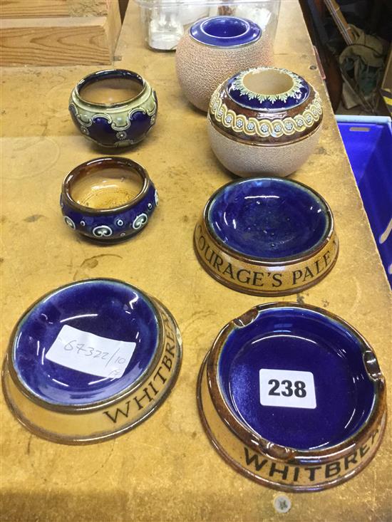 3 x Doulton advertising ashtrays, 2 x match tidies and 2 small pots